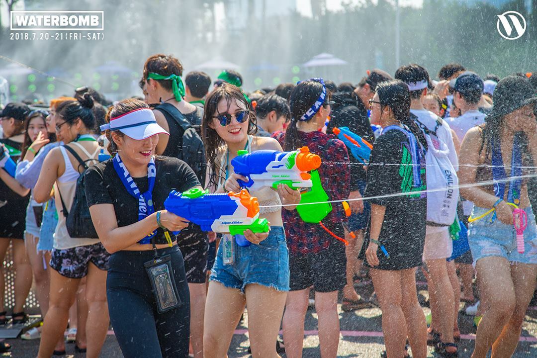 A girl shooting a watergun at Waterbomb.